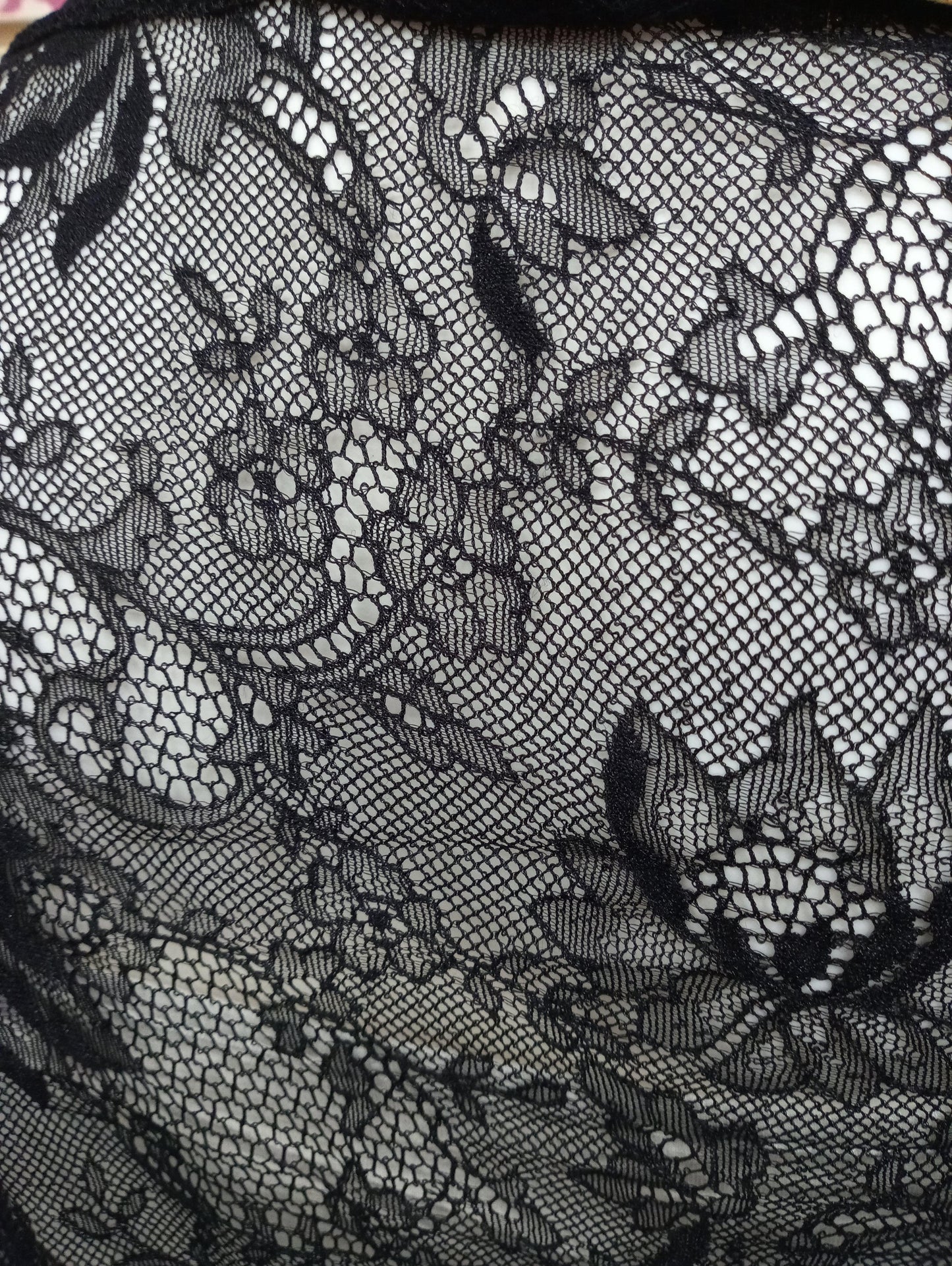Tessuto di pizzo nero con motivo floreale, texture fine e trasparente