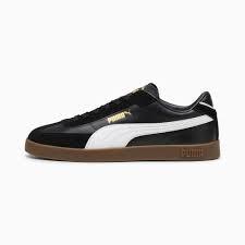 Sneaker streetwear nera in pelle con dettagli bianchi e suola marrone, stile urban.