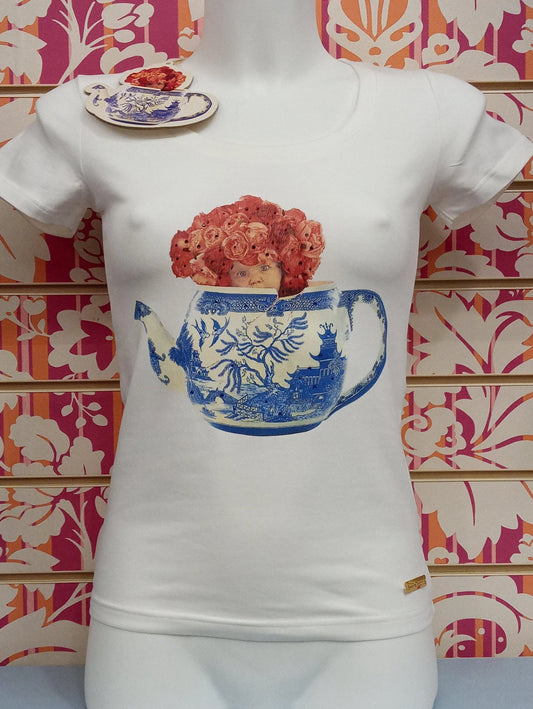 T-shirt donna bianca in cotone stile streetwear, con stampa colorata di teiera blu, volto e fiori rosa, dallo stile urban e creativo.