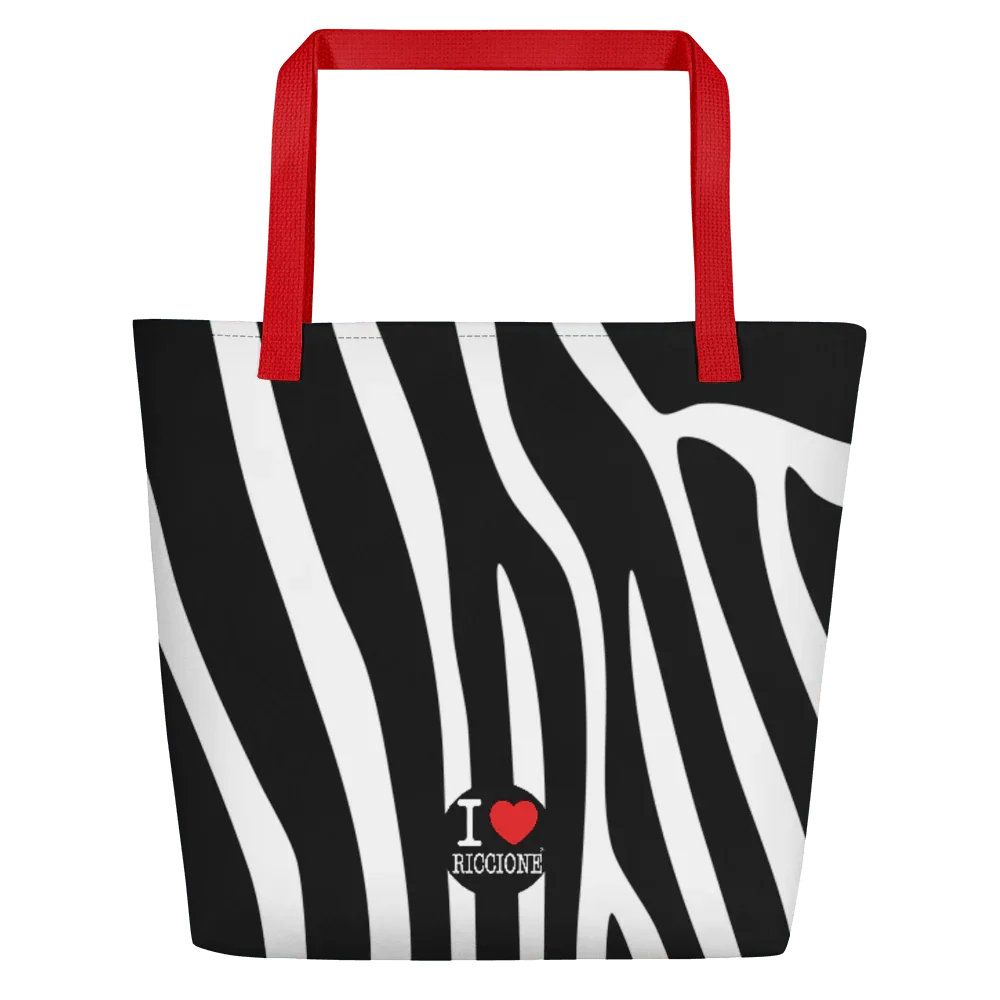 Borsa mare streetwear con fantasia zebrata bianca e nera, manici rossi, scritta I love Riccione.