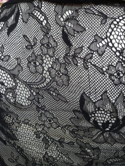 Tessuto di pizzo nero con motivo floreale, texture fine e trasparente
